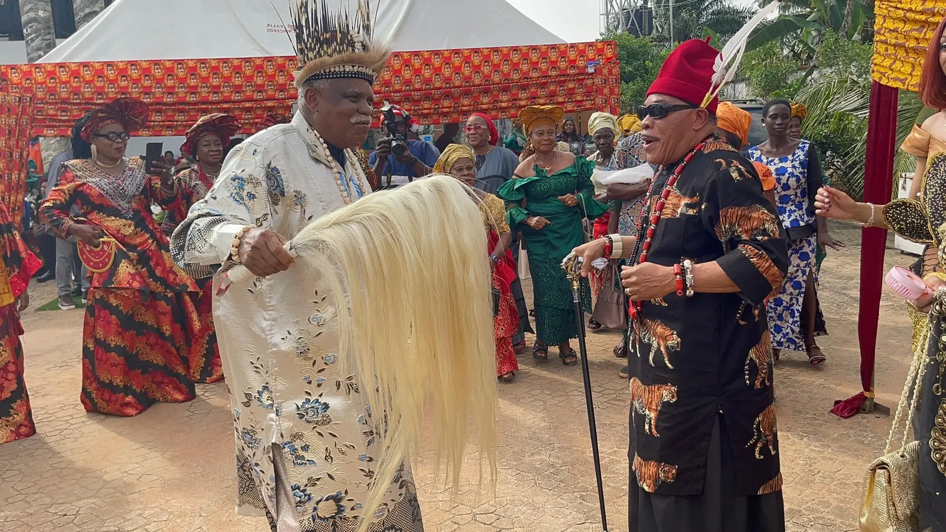Two performers sharing a ceremonial dance at an Igbo Union gathering