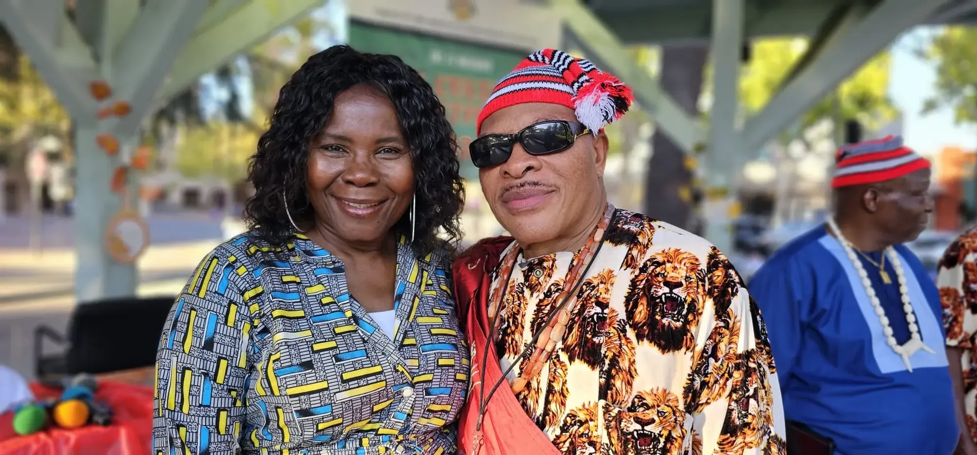 Two Igbo Union members smiling together at an outdoor gathering