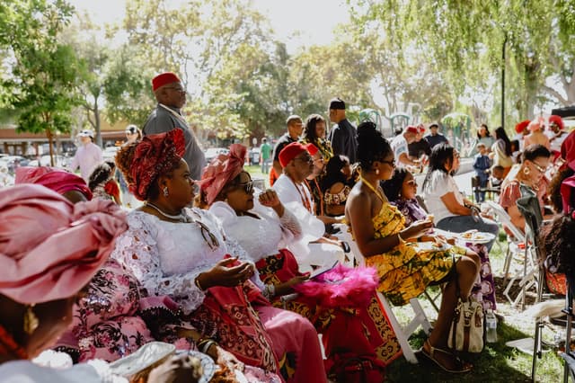 Festival attendees seated beneath the trees at the Igbo Cultural Festival