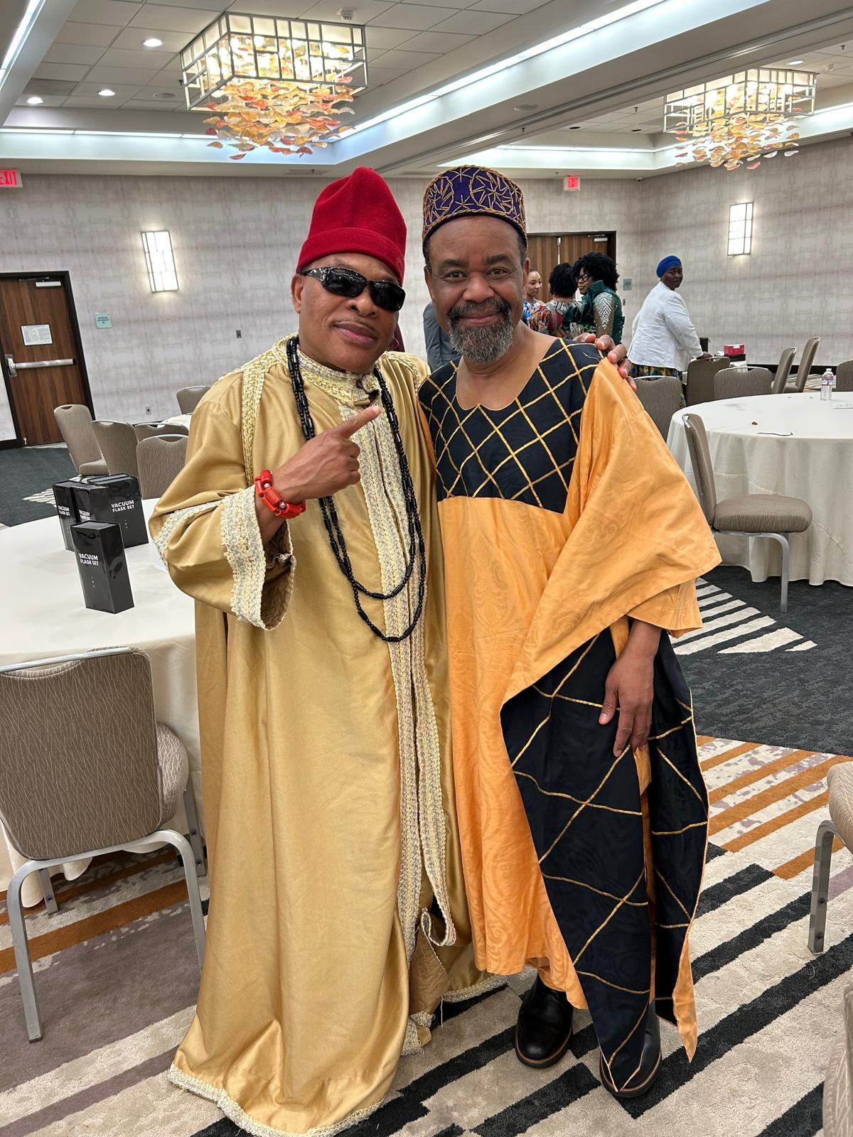 Two community members in coordinated traditional attire