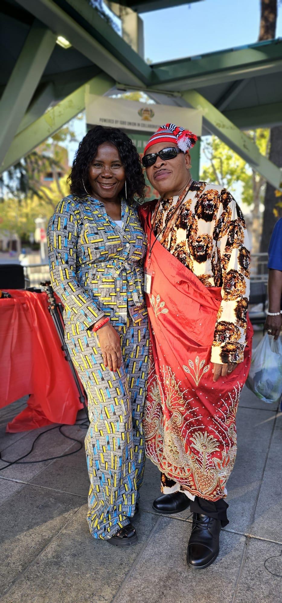 Close view of patterned traditional clothing at an outdoor gathering