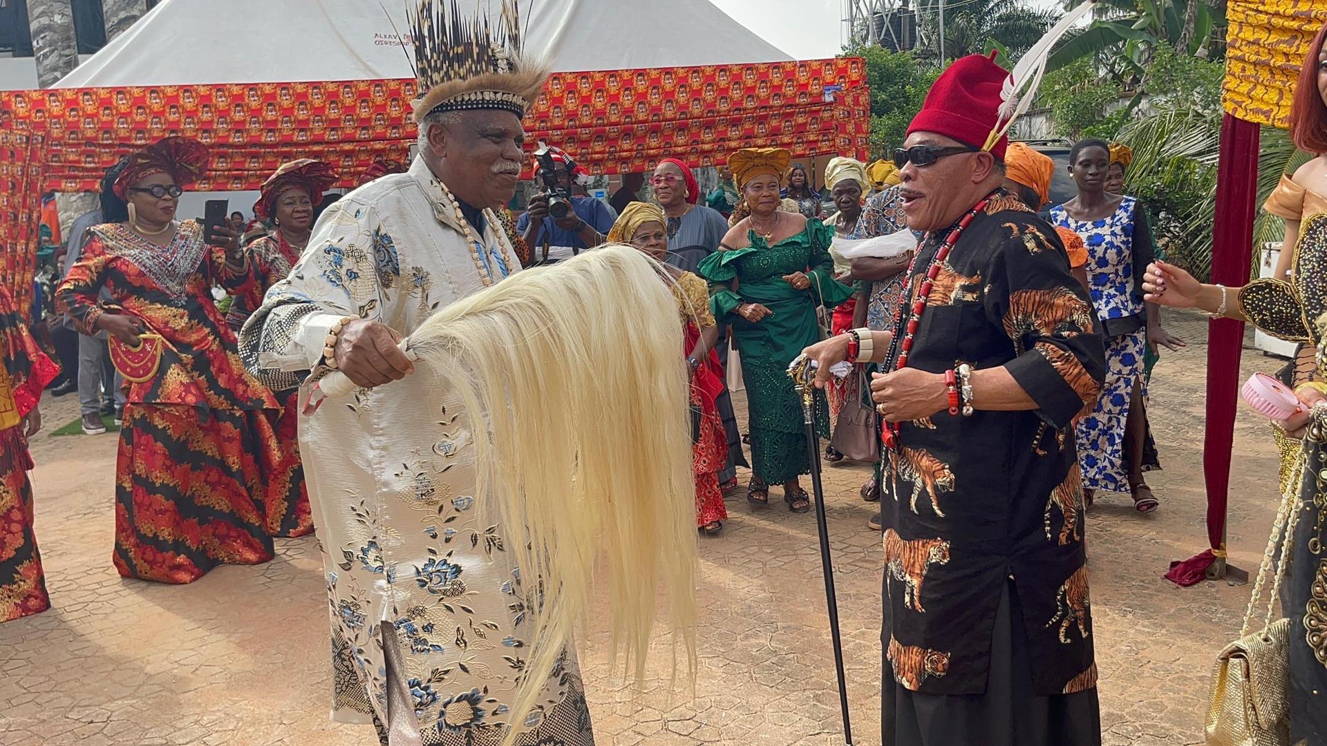Two performers sharing a ceremonial dance at an Igbo Union gathering
