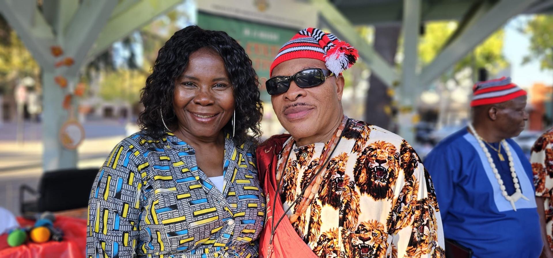 Two Igbo Union members smiling together at an outdoor gathering