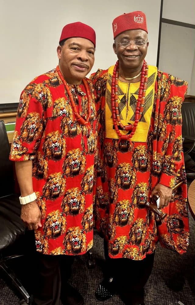 Close view of richly patterned Igbo outfits and coral beads